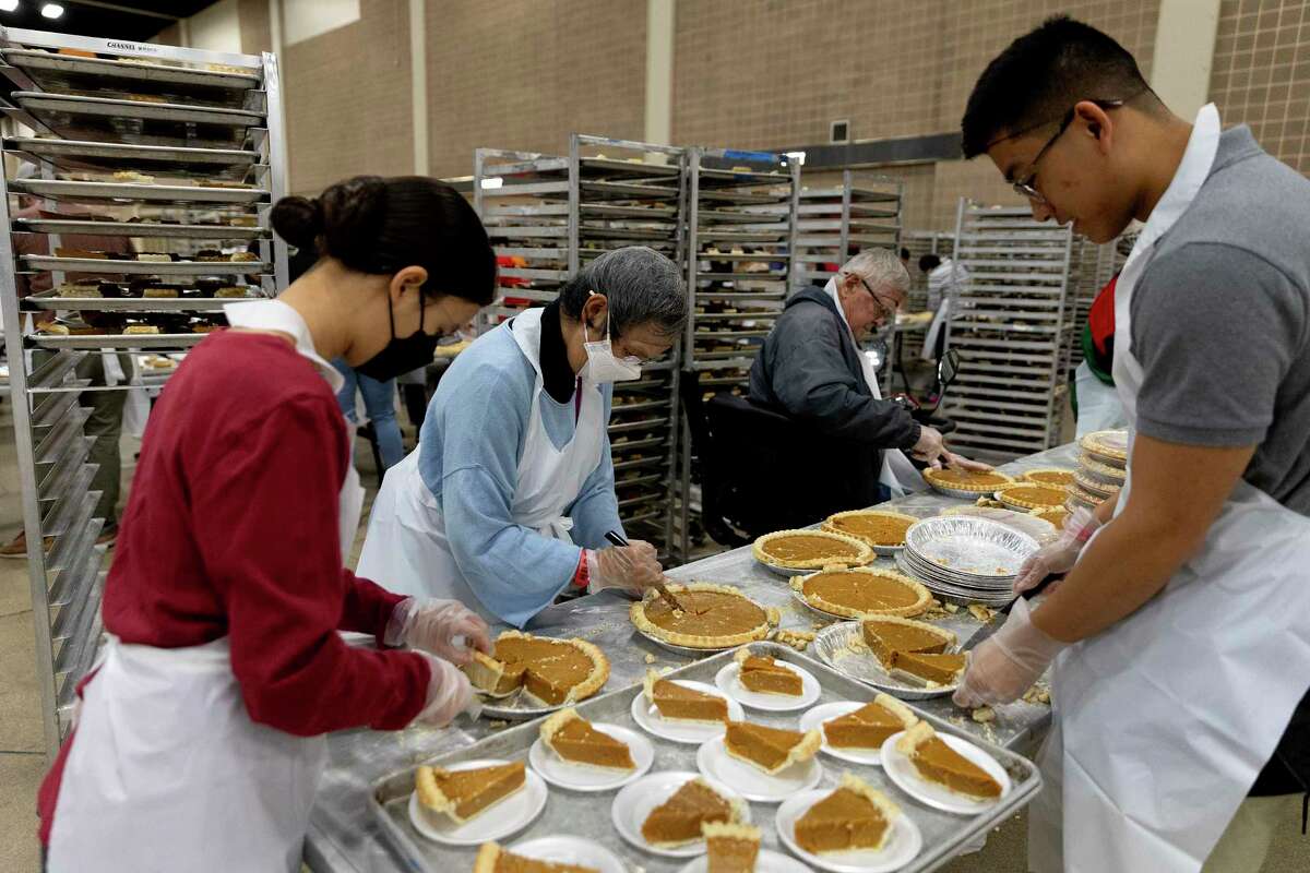 Betty Kwan slices pumpkin pies that will be served to an estimated 25,000 people at the annual Jimenez Thanksgiving dinner. The Thanksgiving feast is held at the Henry B. Gonzalez Convention Center and has been going since 1979. This is the first in person dinner since COVID.
