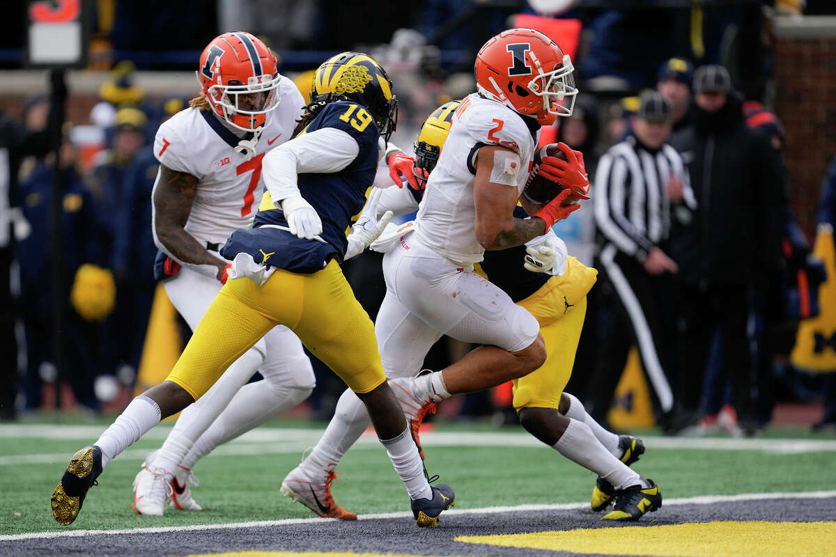 Illinois running back Chase Brown (2) scores on an eight-yard touchdown run against Michigan last Saturday in Ann Arbor.