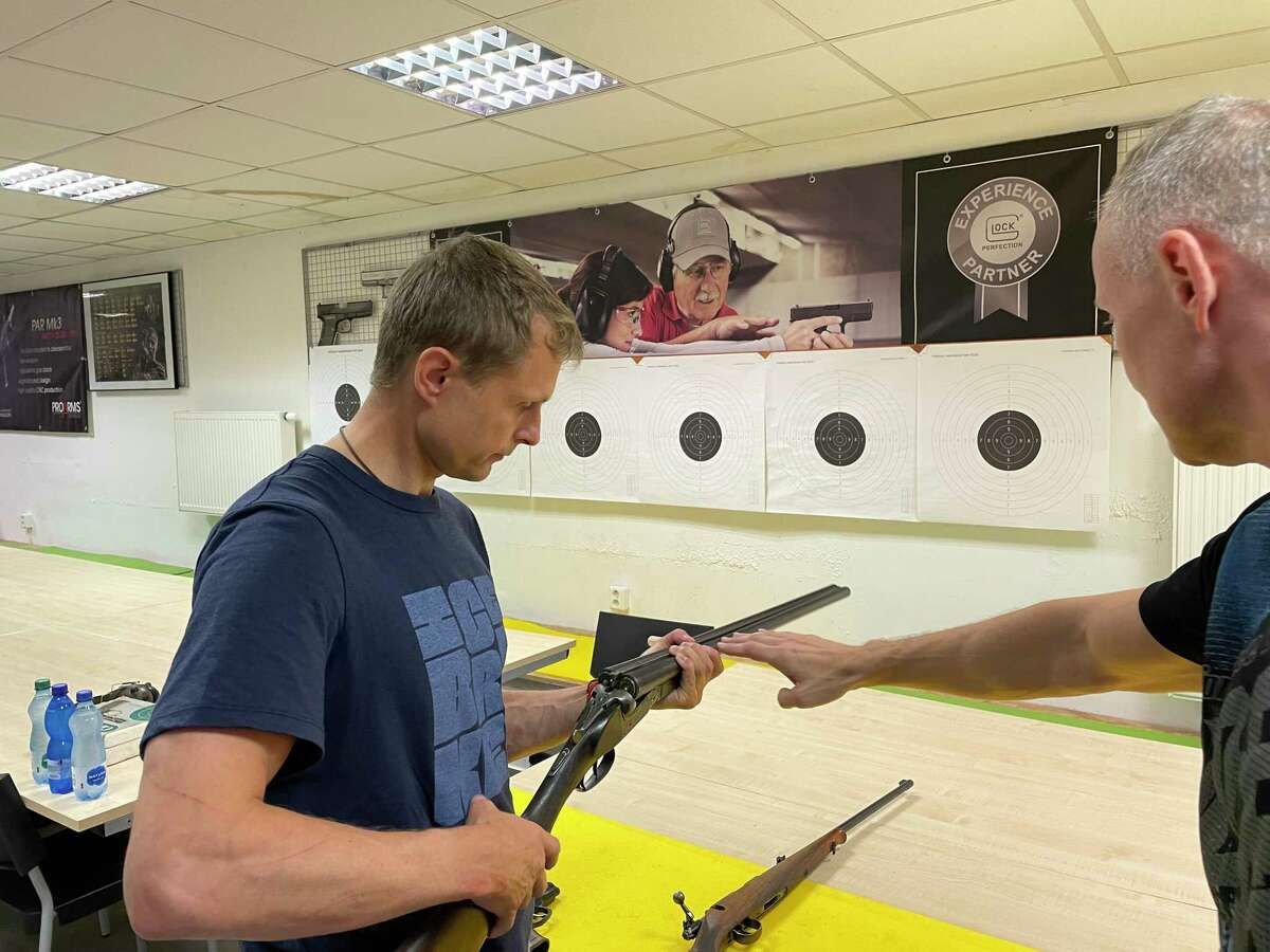 Ludek Cakl, an IT developer from Prague, receives a lesson on safe handling before a test to receive a firearms license.