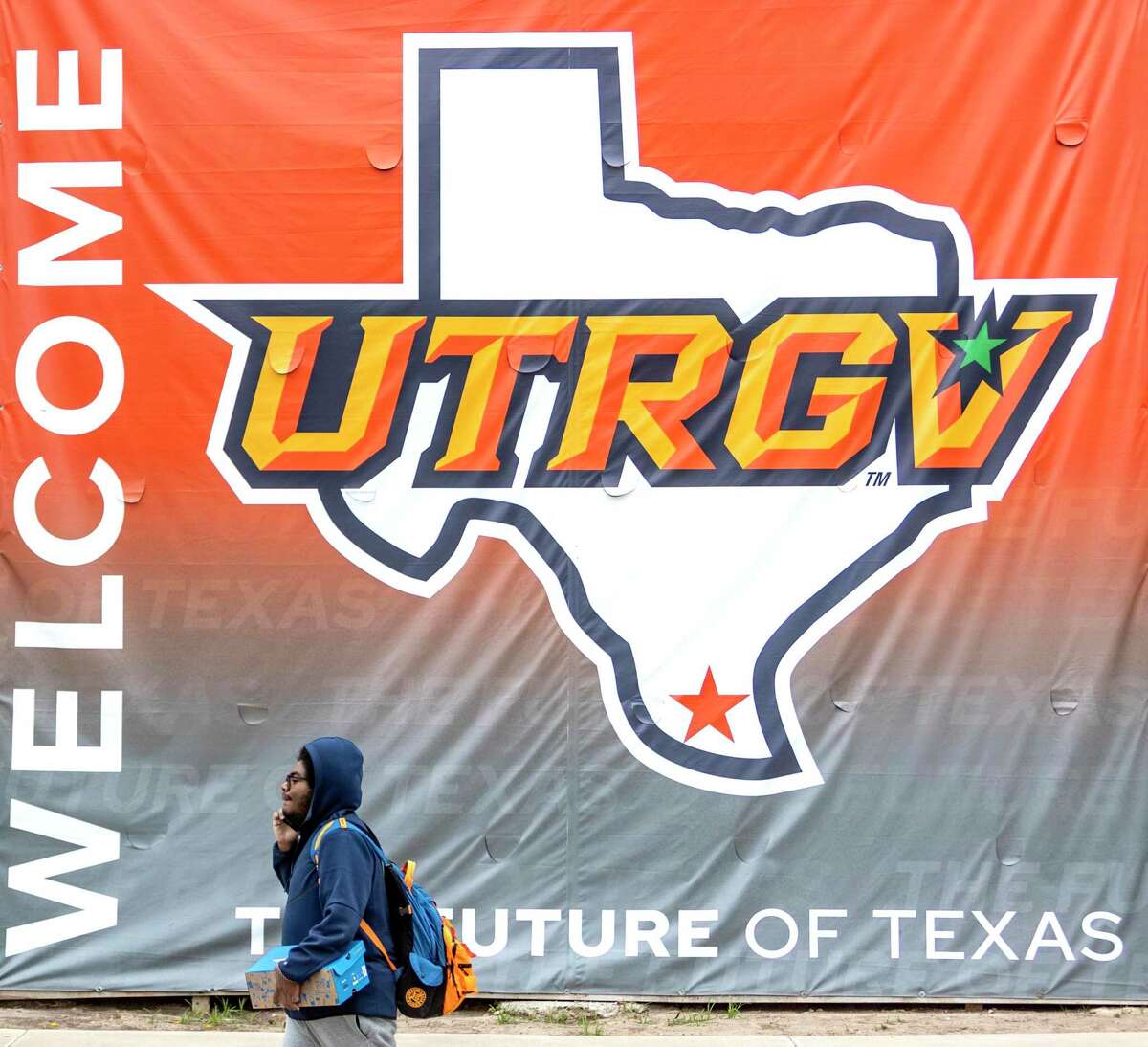 A person walks on the Edinburg campus of the UT-Rio Grande Valley. UTRGV last week got approval from the UT System regents to start a Division I football program and will hire a coach next year.