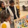 Bobbi Wilson of New Jersey, her sister Hayden Wilson and her mother Monique Joseph look at butterflies at Yale Peabody Museum’s Division of Entomology in New Haven Nov. 16, 2022.