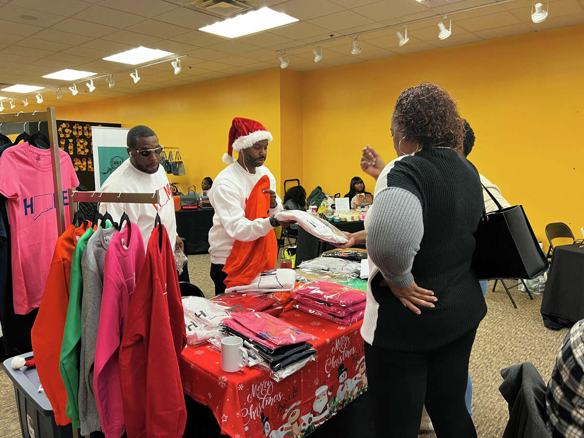 Holiday shoppers check out some of the clothing available at We All Can Win, a pop up shop in The Connecticut Post Mal in Milford, Conn., on Black Friday, Nov. 25, 2022. We All Can Win is a collection of small busineees offering their products at the mall.