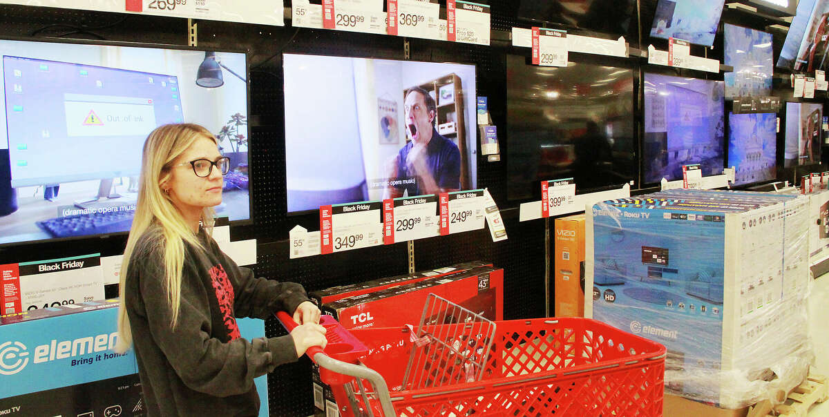 Kelsey Stokes, of Jerseyville, waits for assistance in the electronics section of the Alton Target store Friday morning. The first shopper through the store doors when it opened for Black Friday, she was looking for a specific item, a PlayStation 5, which she was able to get.