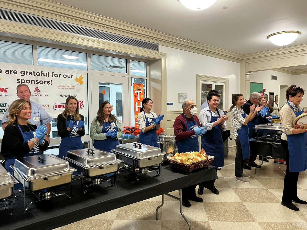 Board members and town officials dish up the special Thanksgiving meal on Tuesday evening at the Boys & Girls Club of Greenwich. 