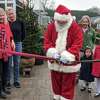 With the cutting of the ribbon by Santa, accompanied by, at left, event organizer Tamara Ketler, sponsor Jenny Allen from Compass, and, at right, Sam Bridge, the annual Reindeer Festival returned to Sam Bridge Nursery and Greenhouses.