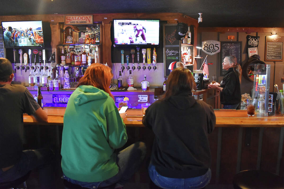 Regan Lopez and Cristle Burton enjoy a drink and some company at the Elkhorn, the second-oldest bar in California.