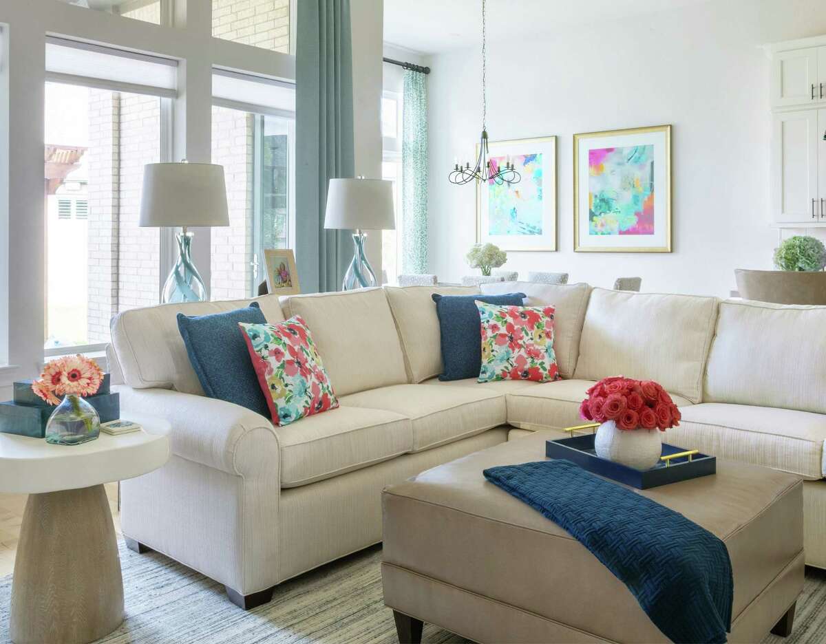 Interior Designer Karen Davis lightened up Margaret Plummer's main living area with white paint and a white sofa, then added color in draperies, pillows and art.