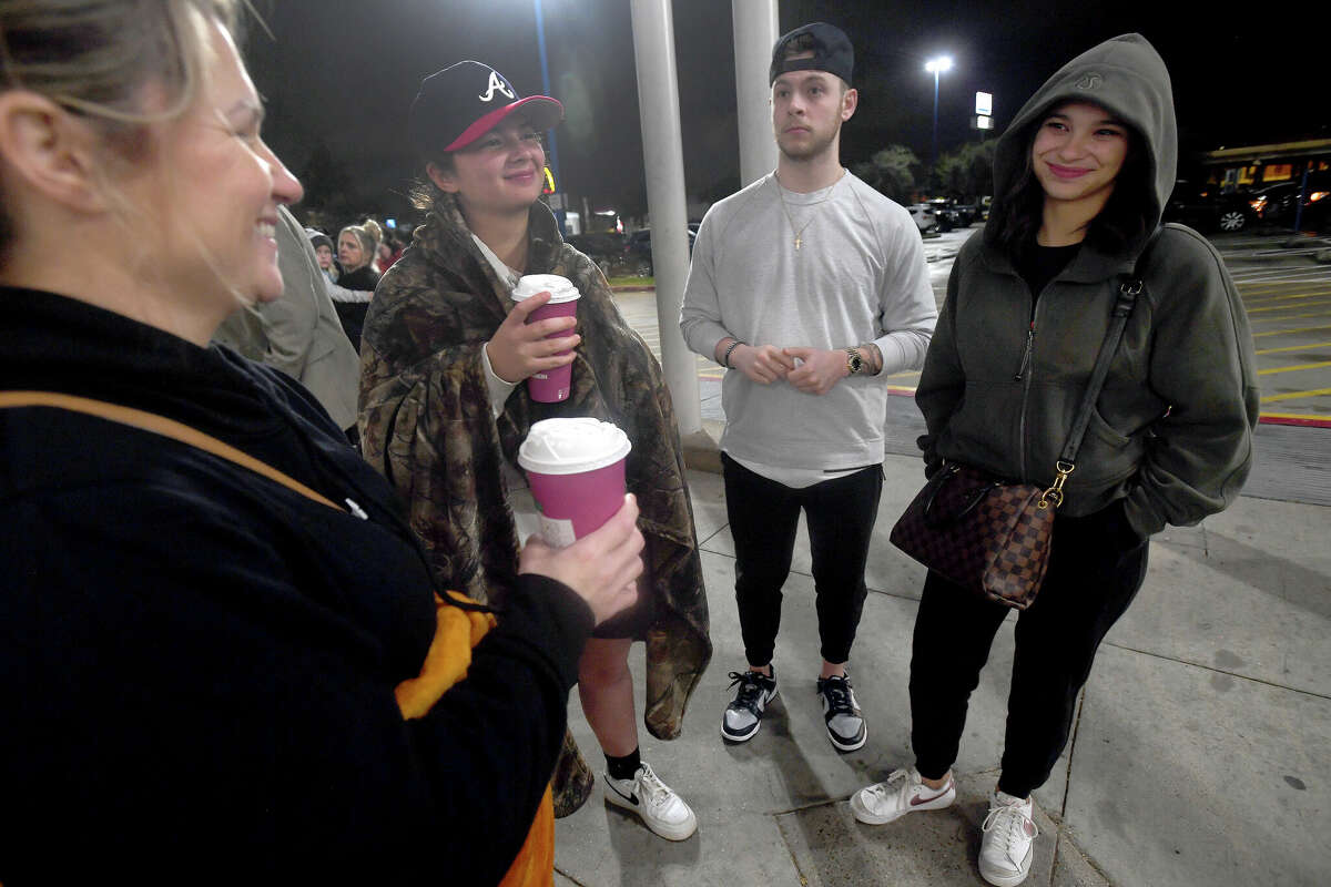 From left, Stacie Ferguson jokes with Kenzie Russell, Zach Dahlenburg and Addison Steltz as they await the 5 a.m. opening at Academy Sports + Outdoors on Black Friday. Photo made Friday, November 25, 2022 Kim Brent/Beaumont Enterprise