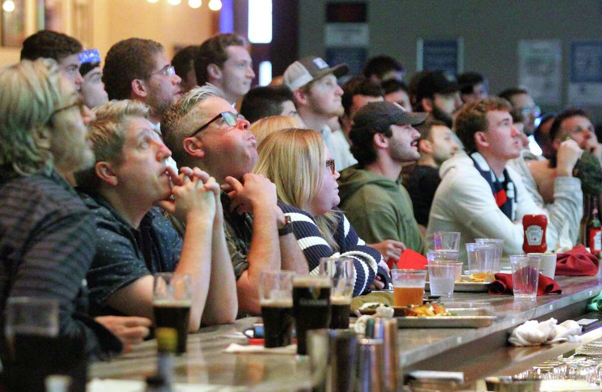 Fans watch World Cup soccer action between the US and England being broadcast at Bobby V's Restaurant & Sports Bar in downtown Stamford, Conn., on Friday November 25, 2022.