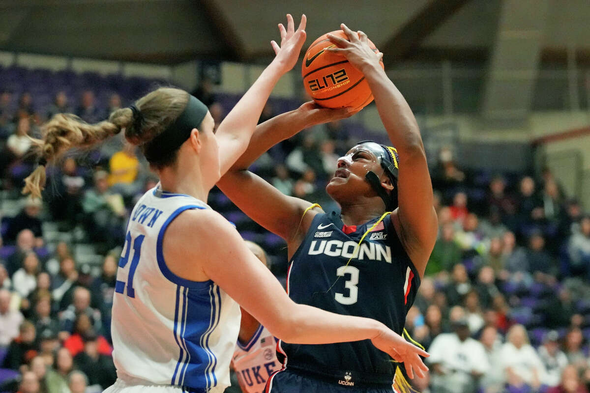 Connecticut forward Aaliyah Edwards (3) shoots as Duke center Kennedy Brown (21) defends during the first half of an NCAA college basketball game in the Phil Knight Legacy tournament Friday, Nov. 25, 2022, in Portland, Ore. (AP Photo/Rick Bowmer)