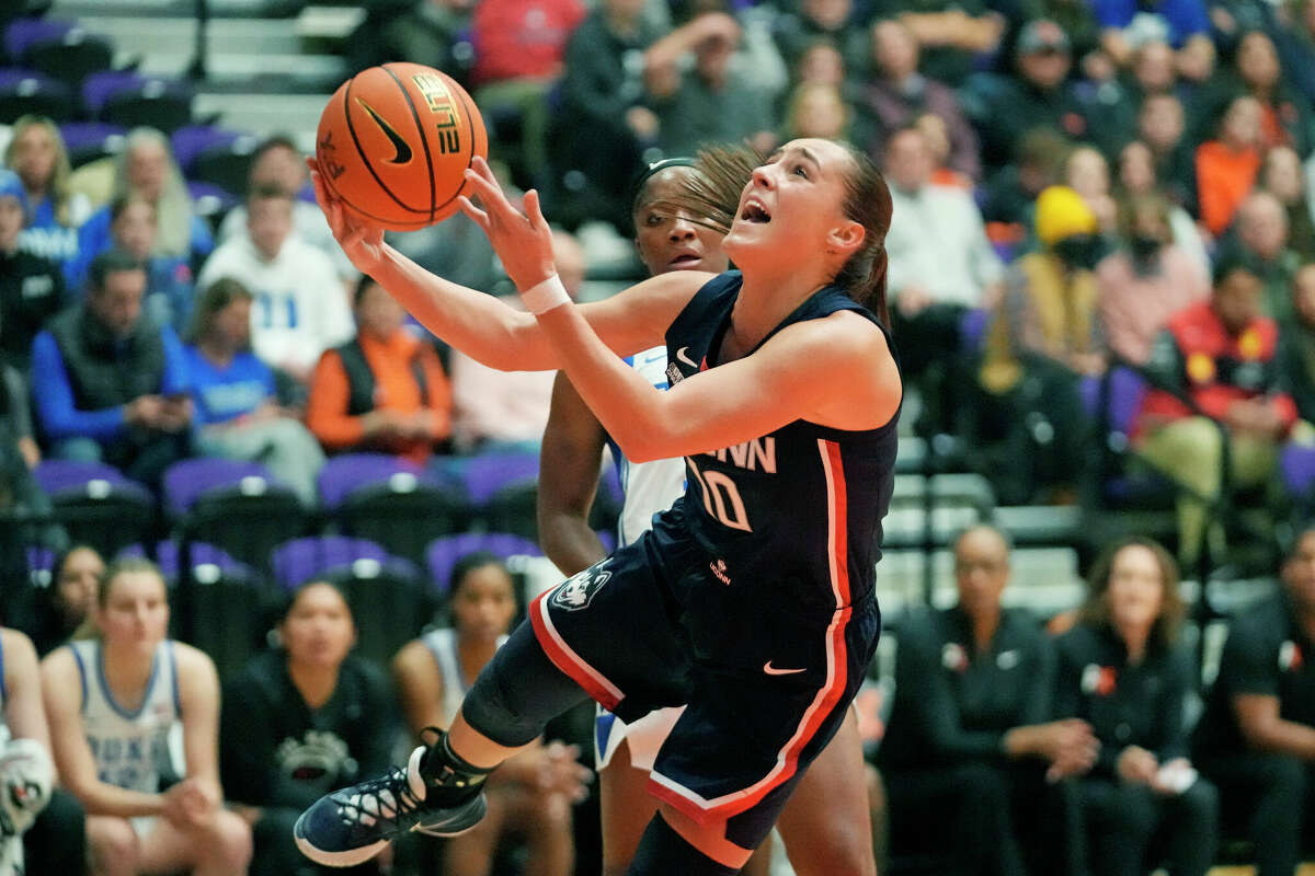 Connecticut guard Nika Muhl (10) goes to the basket against Duke during the first half of an NCAA college basketball game in the Phil Knight Legacy tournament Friday, Nov. 25, 2022, in Portland, Ore. (AP Photo/Rick Bowmer)