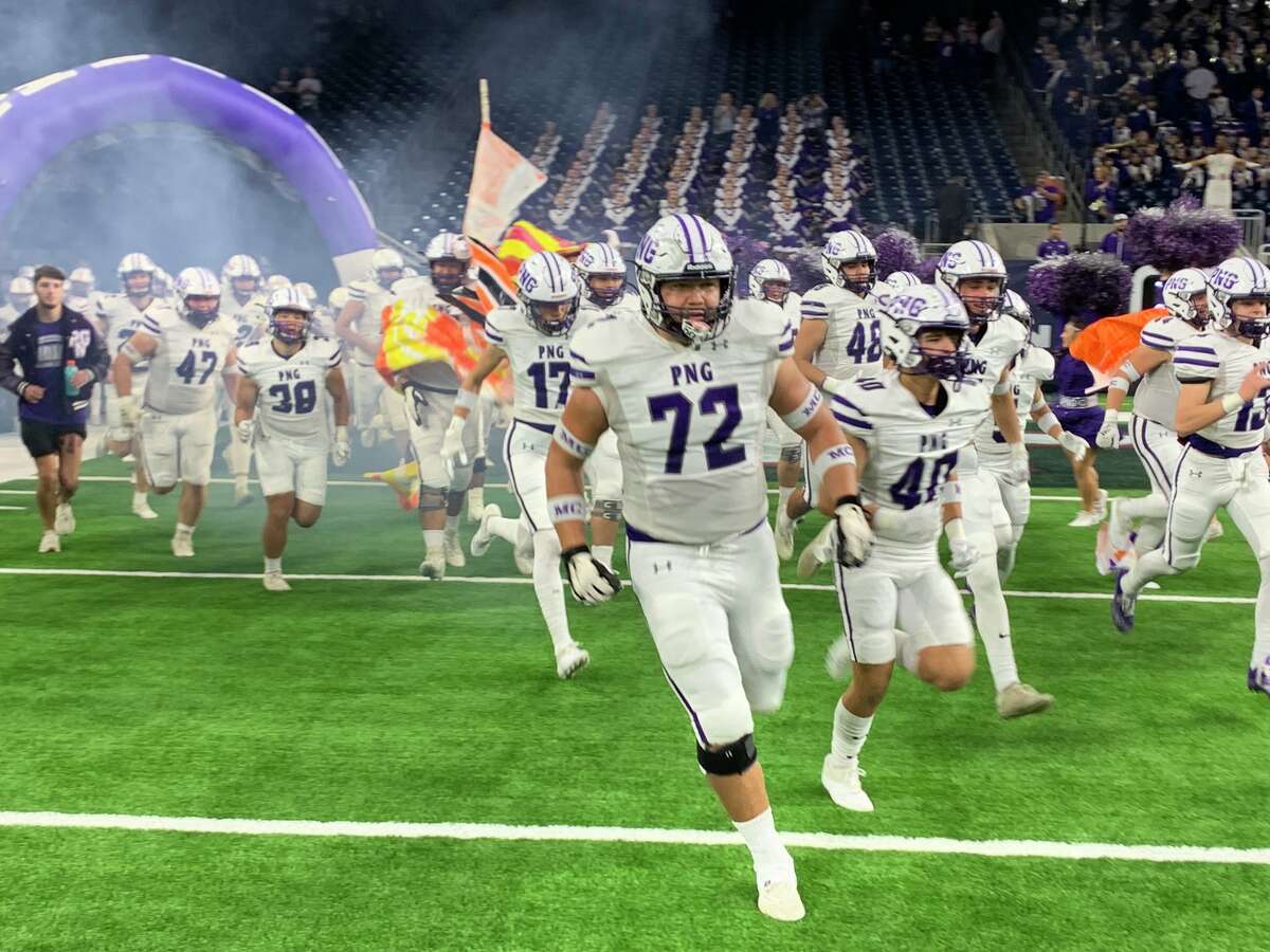 The Port Neches-Groves football team runs out of the tunnel at NRG Stadium in Houston. 
