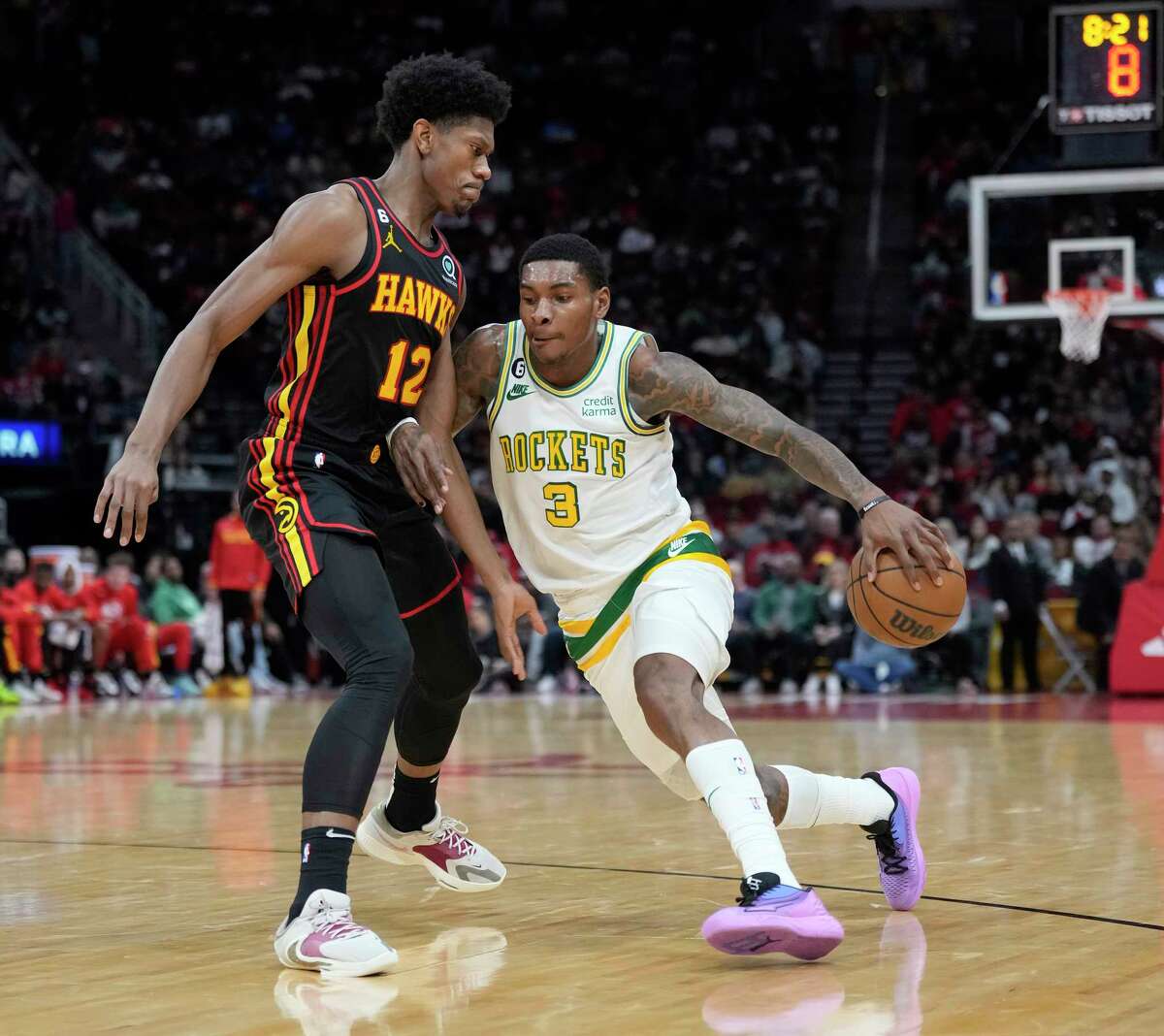 Houston Rockets guard Kevin Porter Jr. (3) drives against Atlanta Hawks forward De'Andre Hunter (12) during the first half of an NBA basketball game at Toyota Center on Friday, Nov. 25, 2022 in Houston .