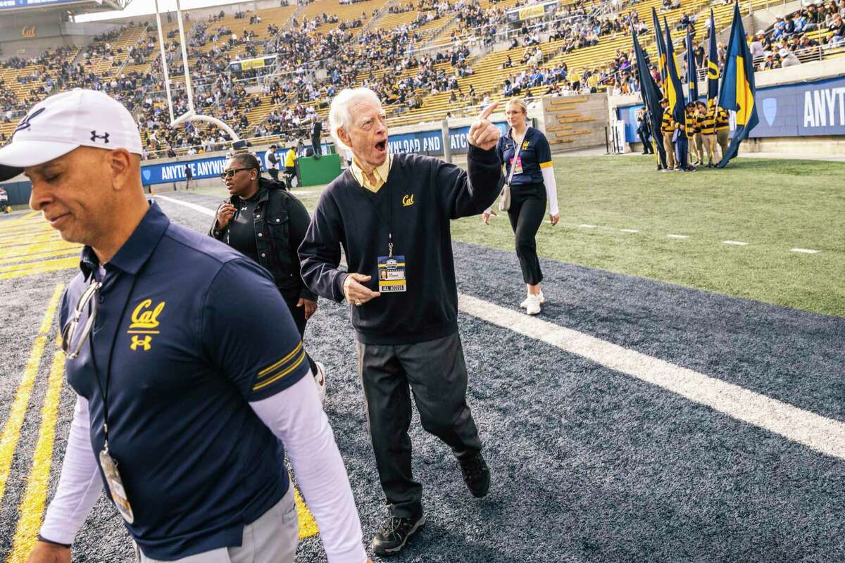 Joe Starkey, radio play-by-play announcer for the California Golden Bears football team, center, reacts as he walks across the field before Starkey’s final game after 48 seasons in Berkeley, Calif. Friday, Nov. 25, 2022.