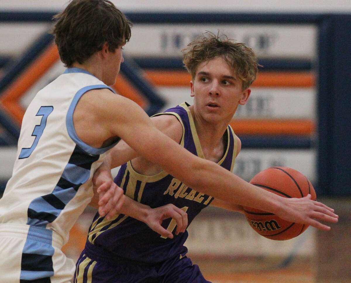 Routt sharpshooter Will Merwin looks over the defense during a boys' basketball game against WIVC rival Triopia Friday night at the Gene Bergschneider Turkey Tournament in New Berlin.