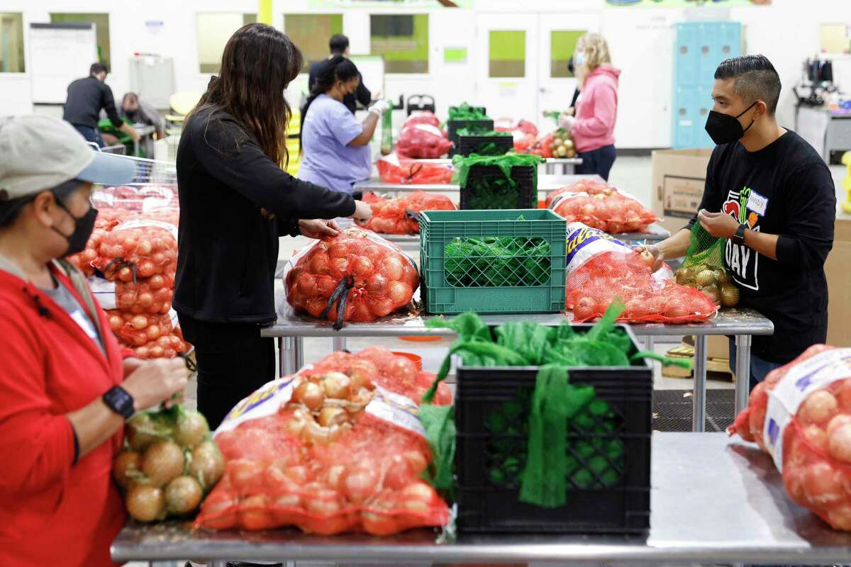 Volunteers from various agencies work at the Alameda County Food Bank in Oakland.