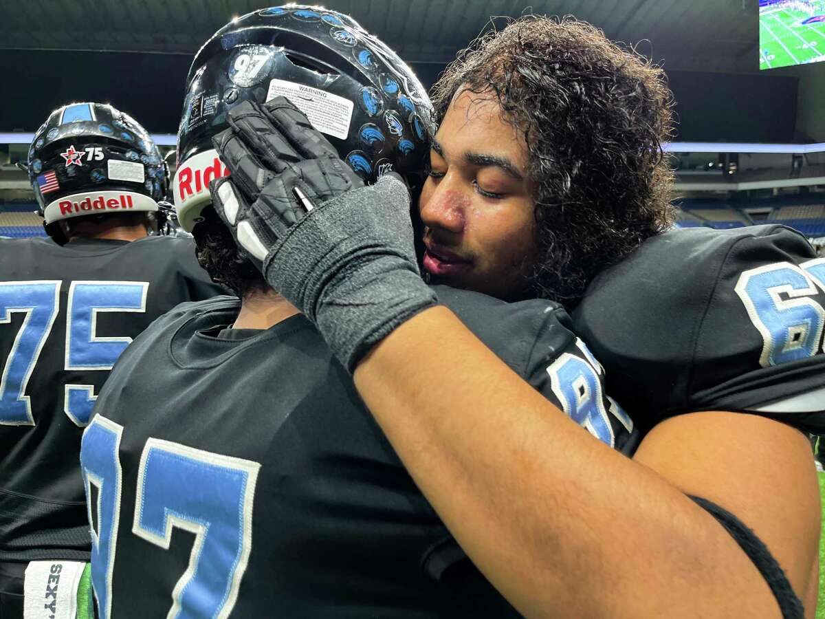Pharrell da Silva Souza, right, comforts Harlan teammate Nathaniel Tealer after they lost to Vandegrift, 49-21, in the Class 6A-II Regional Semifinal football game in the Alamodome on Friday, Nov. 25 2022.