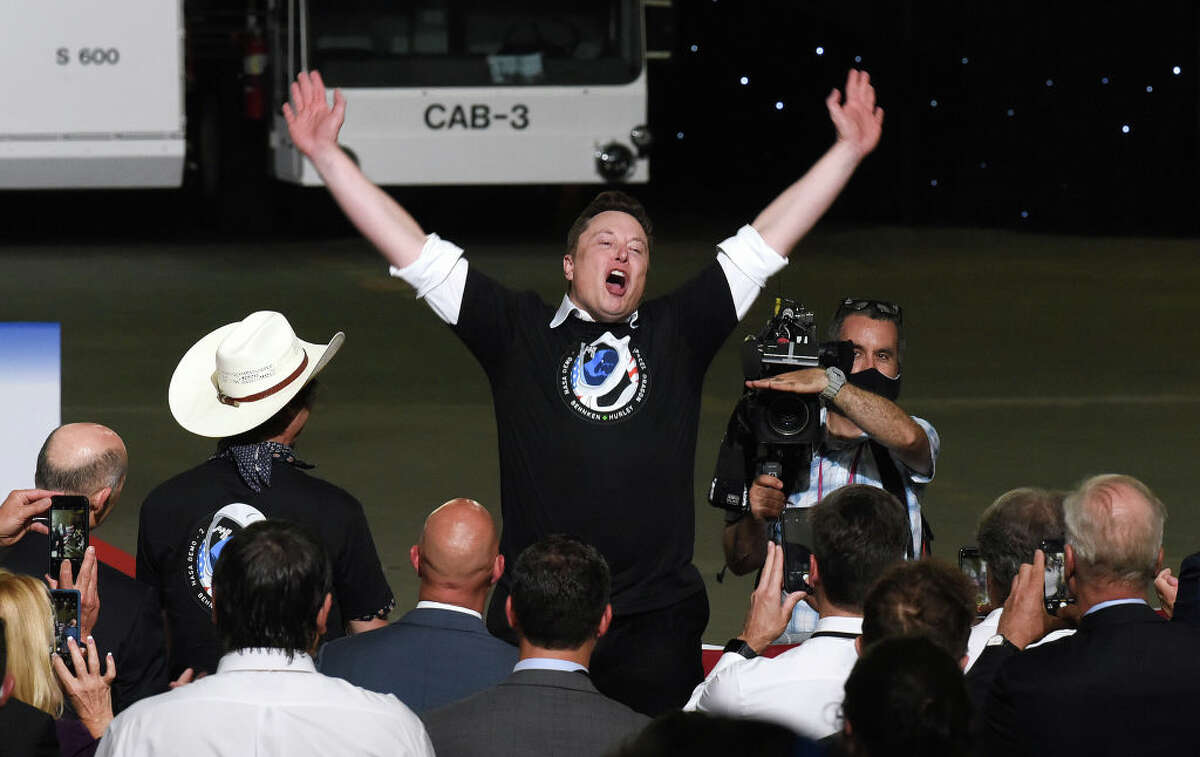 Elon Musk celebrates the successful launch of a Falcon 9 rocket at the Kennedy Space Center during a post launch event at NASA's Vehicle Assembly Building.