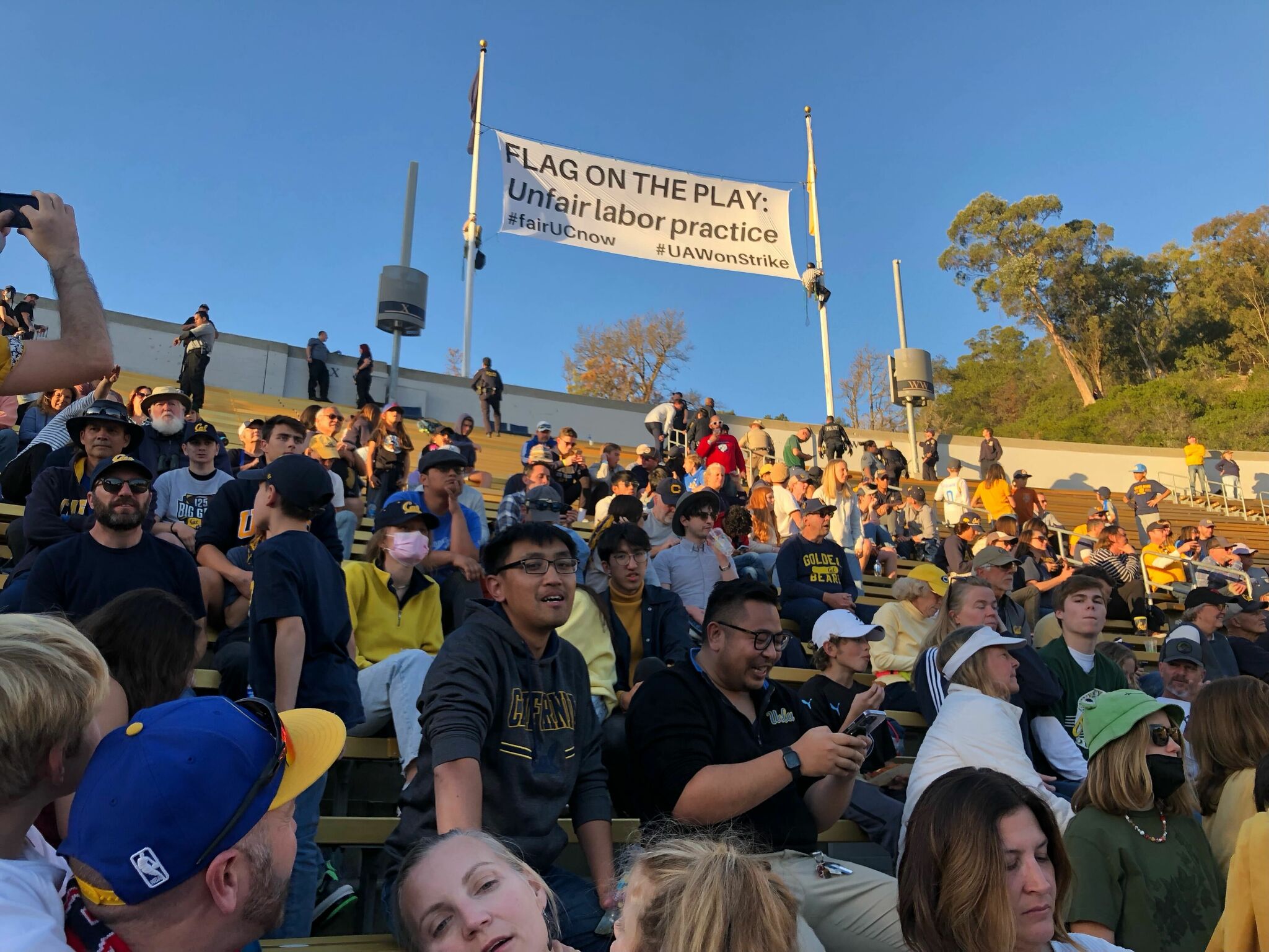 Protestors dressed as refs display banner at Cal football game