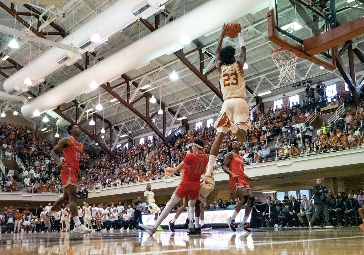 Texas guard Dillon Mitchell (23) goes up for a dunk against Texas Rio Grande Valley forward Dima Zdor (10) during the first half of an NCAA college basketball game, Saturday, Nov. 26, 2022, in Austin.