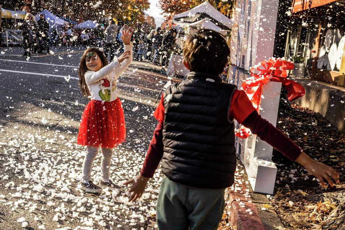 Five-year-old Frances Claire enjoys artificial snow at the San Rafael festival.