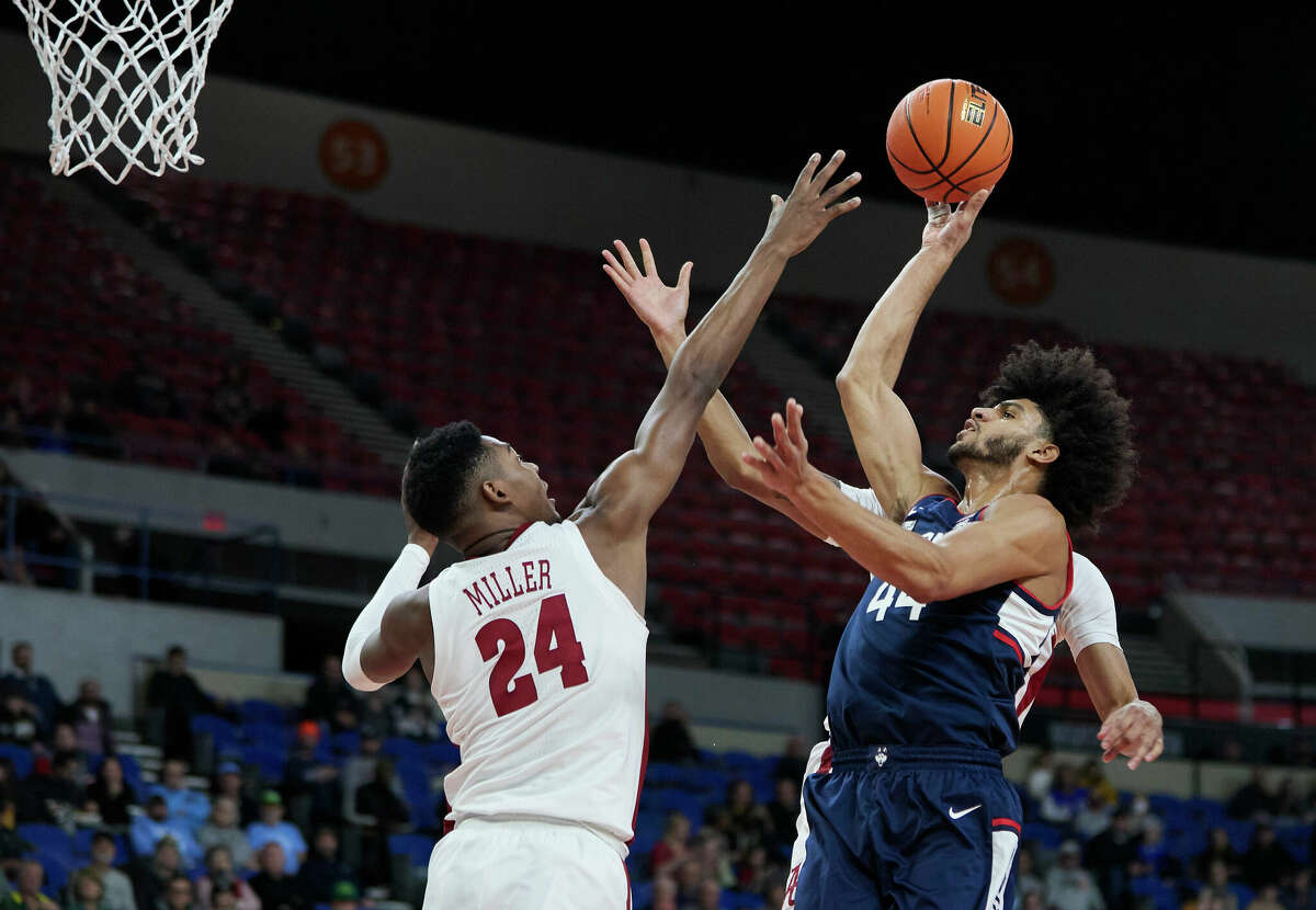 Connecticut guard Andre Jackson Jr., right, shoots over Alabama forward Brandon Miller during the first half of an NCAA college basketball game in the Phil Knight Invitational tournament in Portland, Ore., Friday, Nov. 25, 2022. (AP Photo/Craig Mitchelldyer)