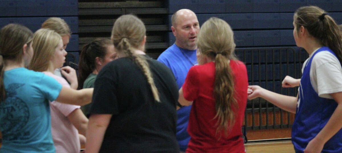 Chippewa Hills coach Aaron Dore (middle) talks to his team after a practice last week.