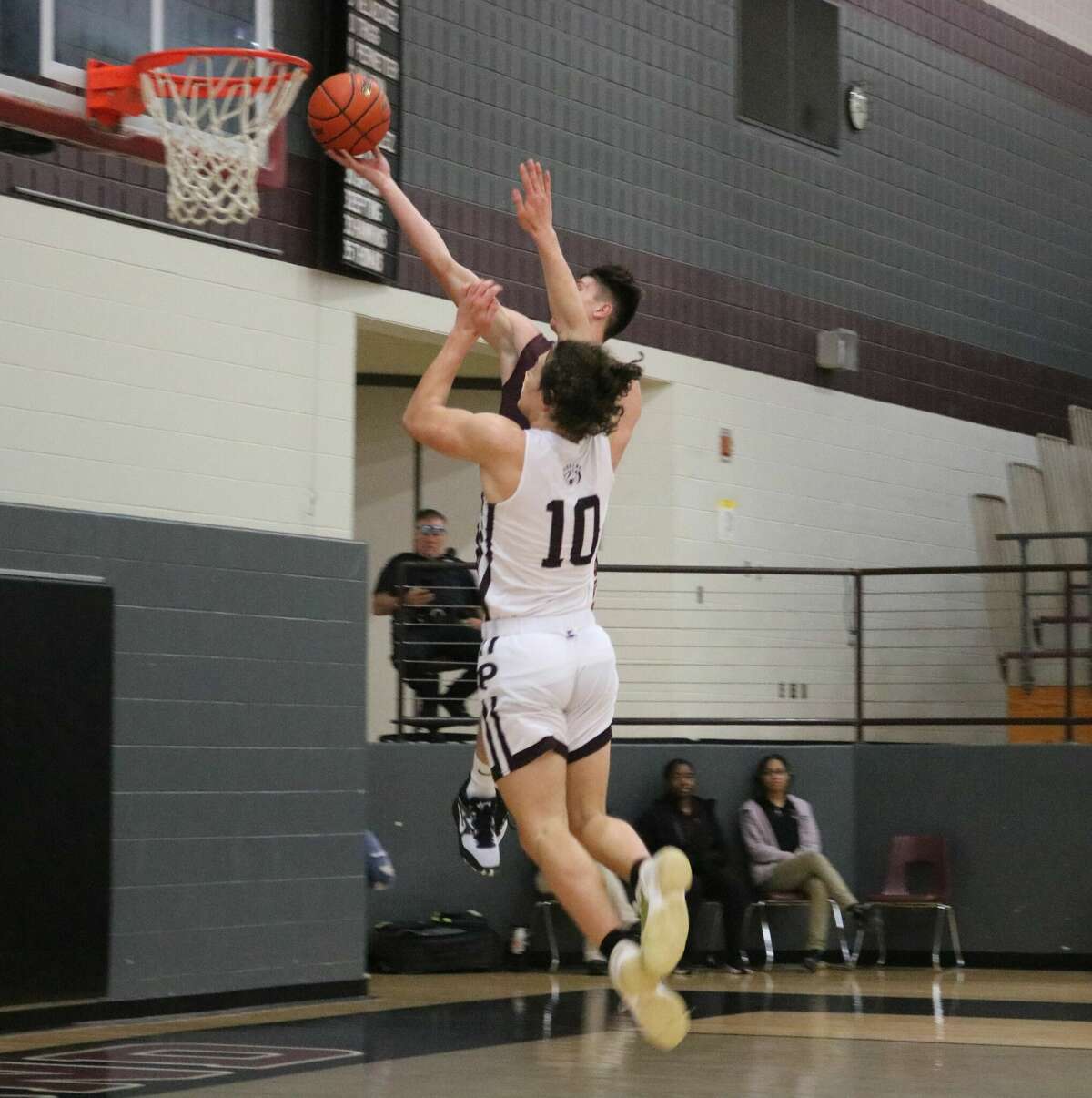 Deer Park's Ryan Clemons attempts to score two of his game-high 17 points in the second period Saturday afternoon after he stole the ball. But he missed and the game stayed tied at 18-18. The Pearland defender is Luke Stano.