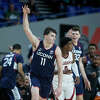 Connecticut forward Alex Karaban (11) reacts after making a 3-point basket next to Alabama guard Jaden Bradley during the second half of an NCAA college basketball game in the Phil Knight Invitational tournament in Portland, Ore., Friday, Nov. 25, 2022. (AP Photo/Craig Mitchelldyer)