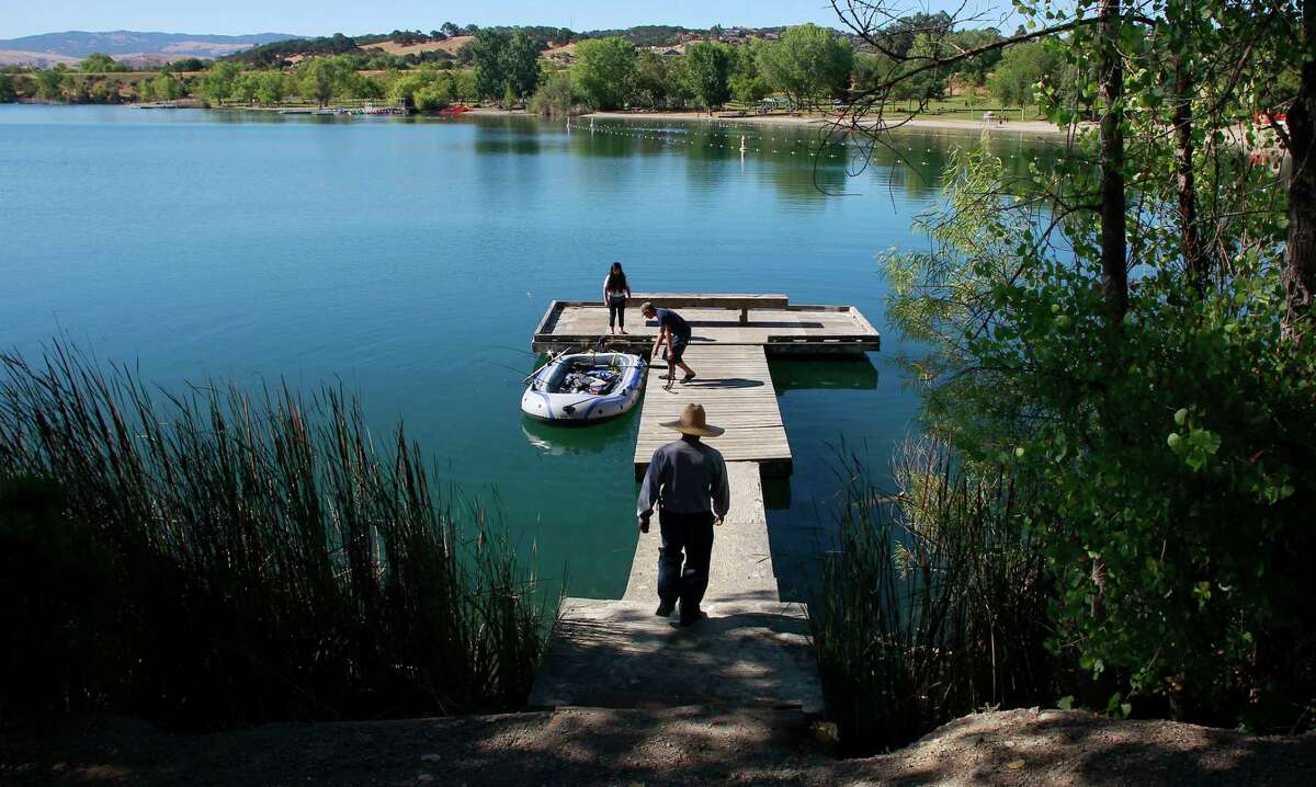 A family prepares to fish from a dock at Shadow Cliffs Regional Recreation Area in Pleasanton in 2013. Crews rescued a woman who was trapped in the mud at the park Saturday.