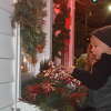 Pierce Griffin, 2, the son of Logan and Ashley Griffin peeks into the Santa House Friday. 