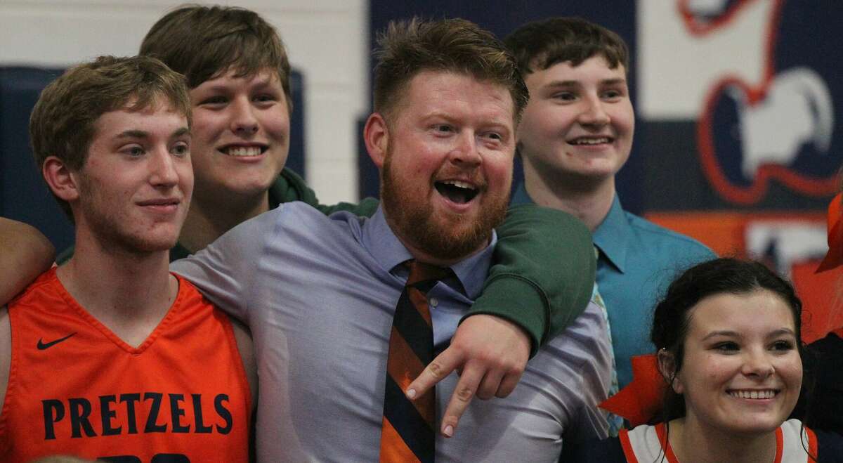 New Berlin coach Blake Lucas poses with his team after the Pretzels beat Routt for the Gene Bergschneider Turkey Tournament championship Saturday night in New Berlin.