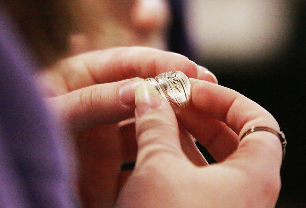 Ginger Finger looks at a silver ring at the Jacoby Arts Center during the annual Green Gift Bazaar, held Saturday at the Post Commons and Jacoby Arts Center. A joint effort by Alton Main Street and the Sierra Club for 20 years, the event offered environmentally friendly goods and is held in conjunction with Small Business Saturday.