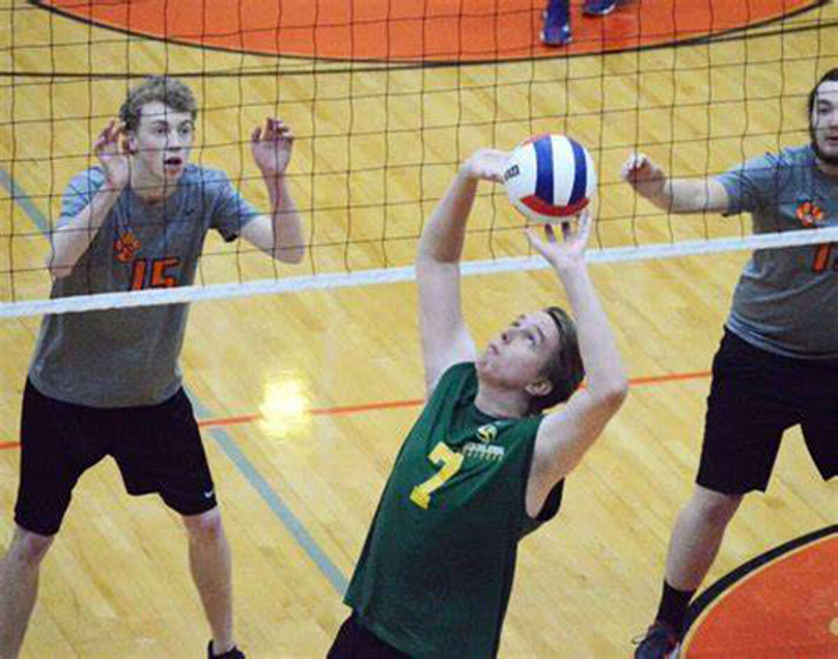 Metro-East Lutheran graduate A.J. Risavy sets the ball during his volleyball playing days at MELHS.