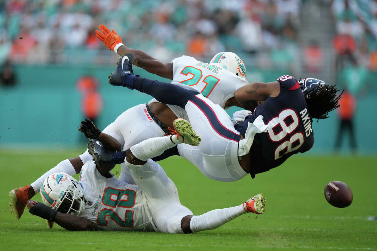 Miami Dolphins safety Eric Rowe (21) knocks the ball loose from Houston Texans tight end Jordan Akins (88) during the game between the Houston Texans and the Miami Dolphins on Sunday, November 27, 2022 at Hard Rock Stadium in Miami Gardens, Florida.