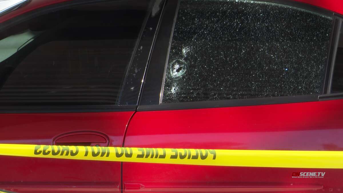A car window a bullet hole after six men allegedly ambushed the car and shot at four men inside, Houston police said.