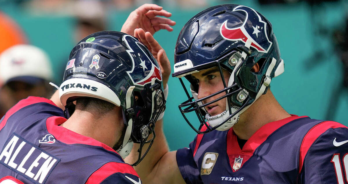 Houston Texans quarterback Kyle Allen (3) and Houston Texans quarterback Davis Mills (10) run onto the field to warm up before an NFL football game against the Miami Dolphins Sunday, Nov. 27, 2022, in Miami Gardens, Fla.