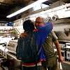 Zero Zero owner Bruce Hill (right) gives bartender Tim Abellera a hug goodbye. After hanging on during the pandemic, the San Francisco pizza restaurant closed this month.