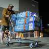 John Beezley, of Bonham, carts out several cases of water after learning that a boil water notice was issued for the entire city of Houston on Sunday, Nov. 27, 2022, at Walmart on S. Post Oak Road in Houston. Beezley just arrived in town with his wife, who is undergoing treatment starting tomorrow at M.D. Anderson Cancer Center, where they are staying in a camping trailer. They turned on the television after settling in and saw that a boil water notice had been issued. Beezley decided to go out immediately fearing that by tomorrow people would be buying up all of the available water.