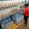People buy bottled water after a boil water notice was issued for the entire city of Houston on Sunday, Nov. 27, 2022, at Walmart on S. Post Oak Rd. in Houston.