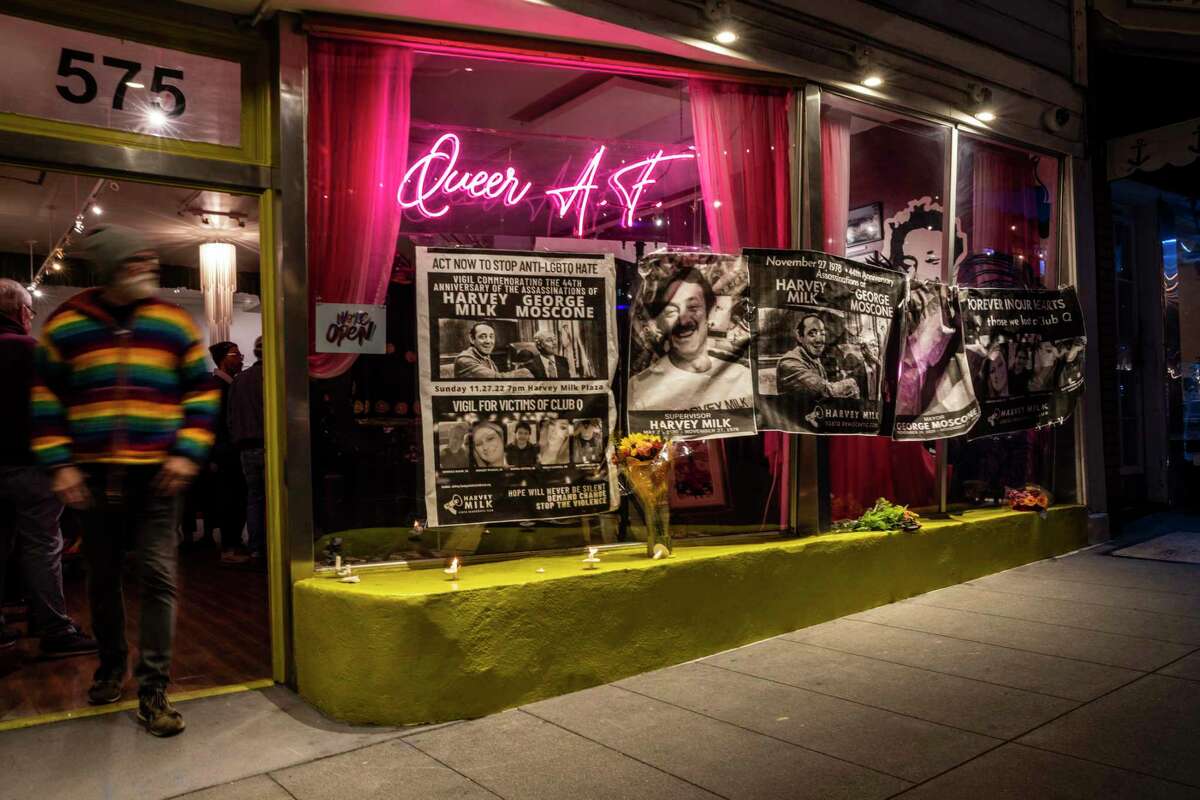 Posters are seen outside 575 Castro Street, formerly Castro Camera and Harvey Milk Residence, during a vigil Sunday night for the 44th anniversary of the assassinations of Harvey Milk and Mayor George Moscone and last week’s mass shooting at Club Q, a LGBTQ club in Colorado Springs, Colo.