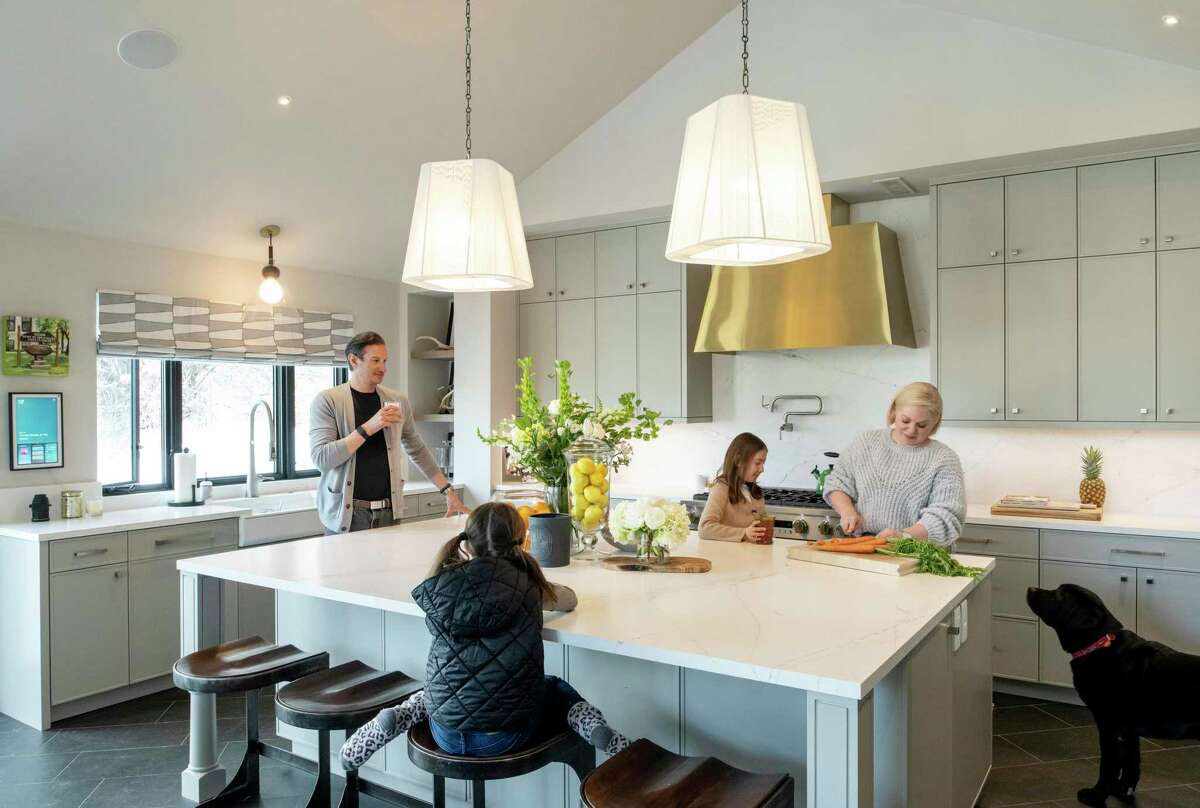 Laura and Michael Umansky with their twin daughters, Liv, seated, and Ryan, and dog, Archie, have a kitchen that’s all about function.