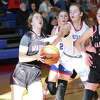 Roxana's Lila Simon (left) drives to the basket against Roxana in a game on Saturday morning at Milazzo Gym in Roxana.
