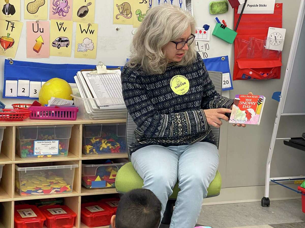 Selectperson Janet Stone McGuigan reads “The Snowy Day” to young students at New Lebanon School in Greenwich last week.