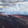 Aerial view of Mauna Loa on Hawai'i Island erupting from vents on the Northeast Rift zone. Flows are moving downslope to the north. Nov. 28, 2022