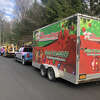 The Christmas Guys convoy includes a festive hauling trailing and boom truck to access high trees and peaks. 