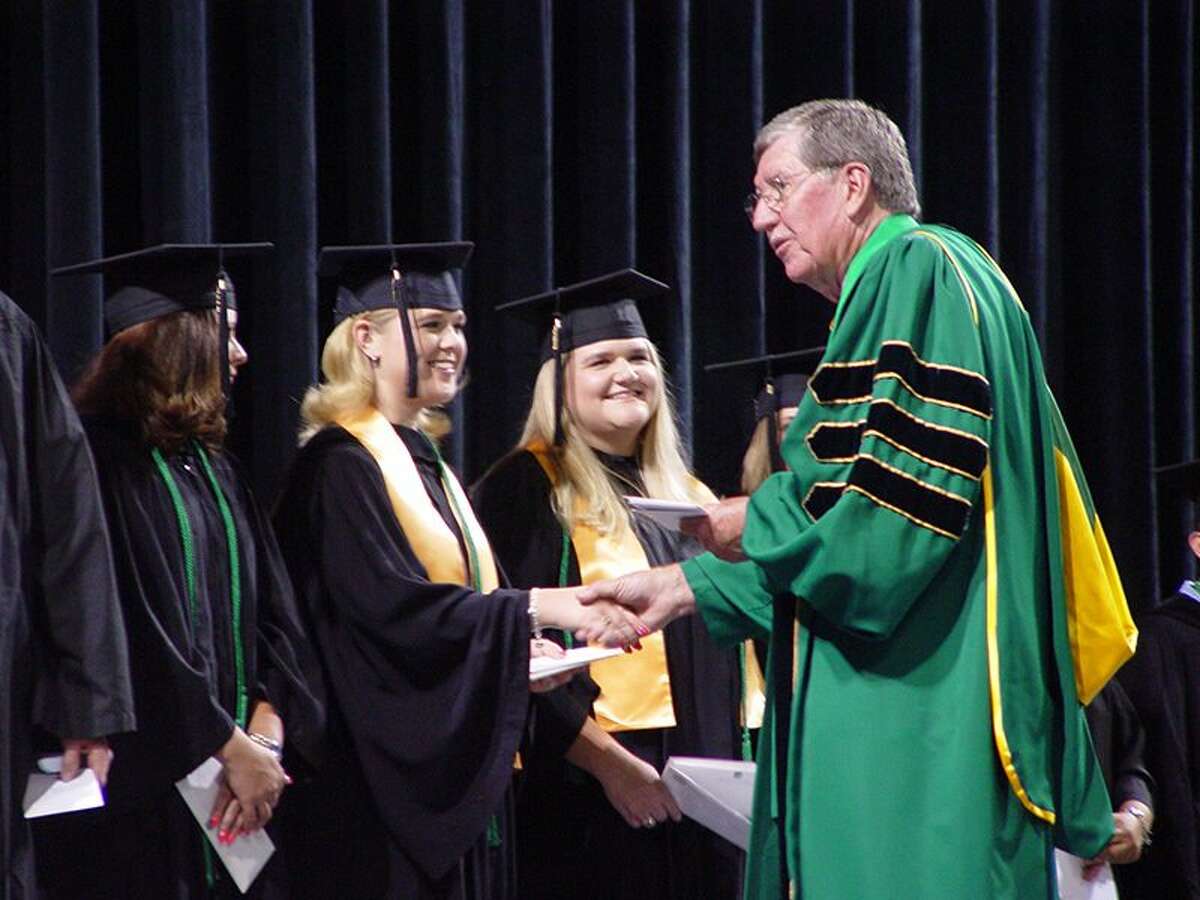 David Daniel shakes student's hand at the May 2003 MC graduation ceremony