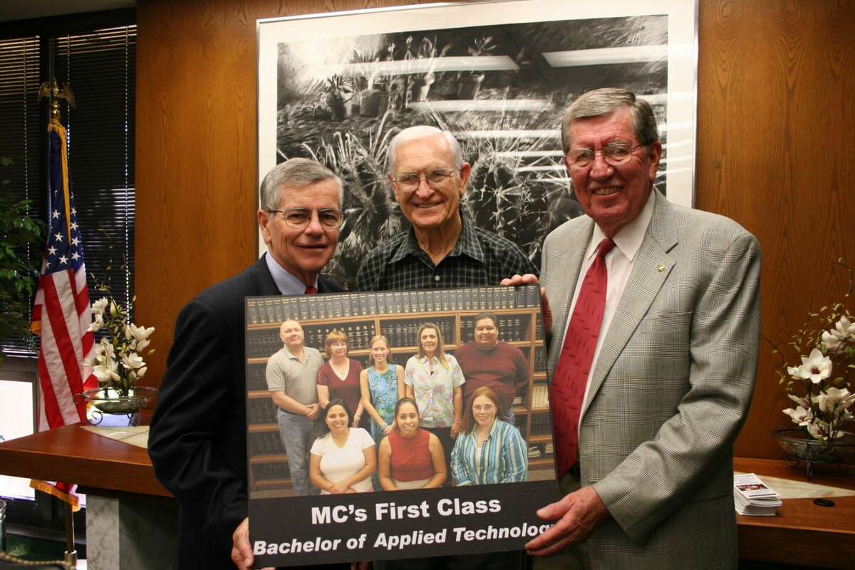 From left to right, state Rep. Tom Craddick; Ken Peeler, retired MC board trustee; and David Daniel hold photo of first graduating baccalaureate degree class.