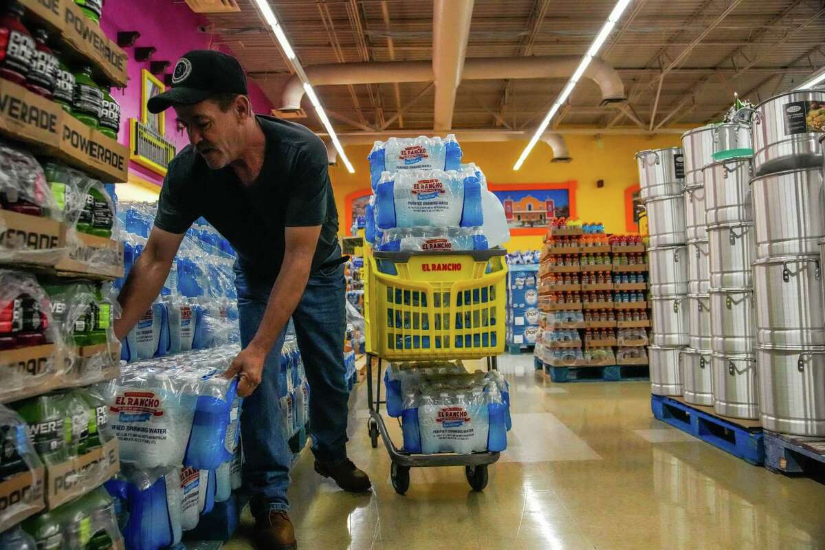 Rodolpho Bolaños stocks up on water for his family after a boil water notice was issued Monday, Nov. 28, 2022, in Houston. The city of Houston issued the notice late Sunday evening after water pressure dropped below the minimum standard during a power outage at the East Water Purification Plant around 10:30 a.m.