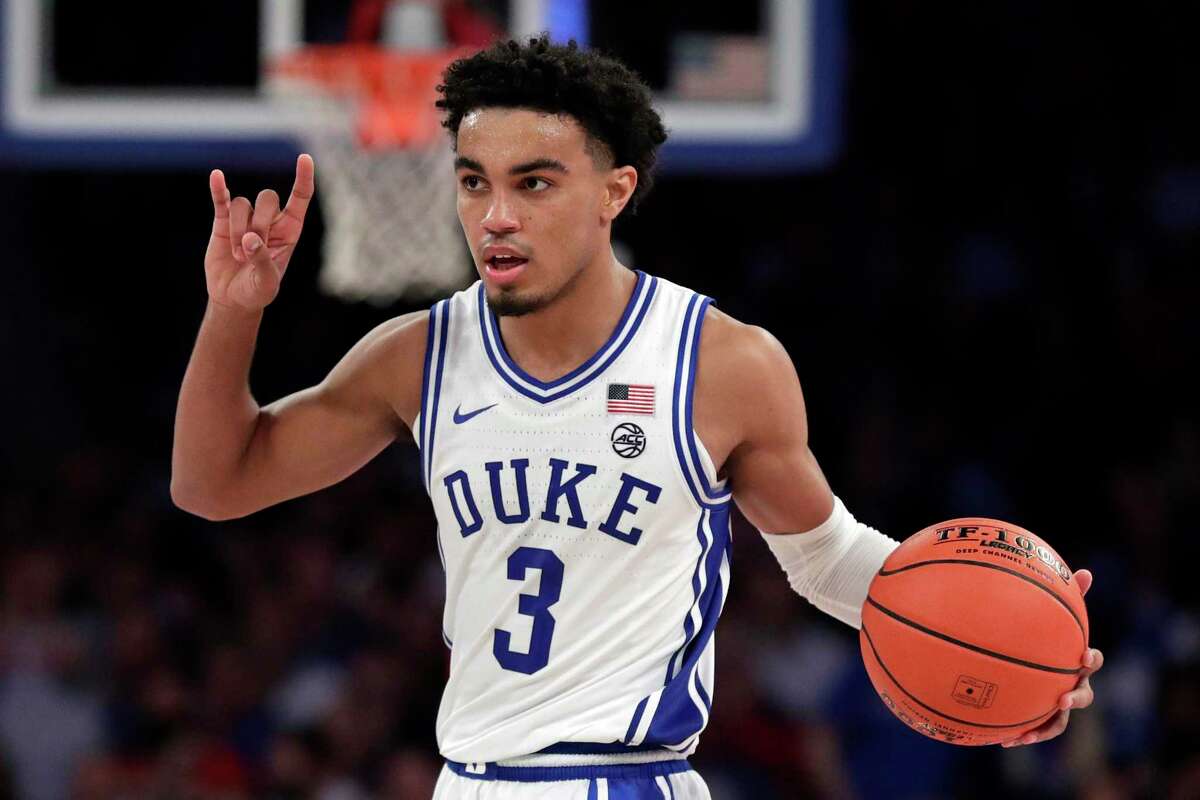 Duke guard Tre Jones signals to teammates during the second half of the team's NCAA college basketball game against Kansas on Tuesday, Nov. 5, 2019, in New York. (AP Photo/Adam Hunger)